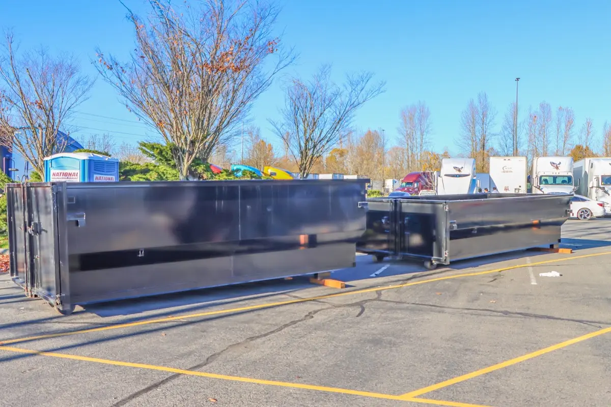 Professional dumpster rental service with roll-off container on residential driveway in Socorro